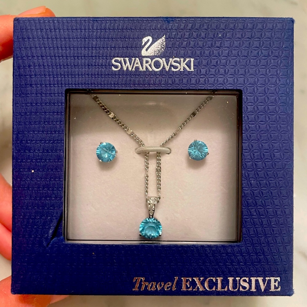 Swarovski brand new- never worn necklace and earring set. Light blue color.